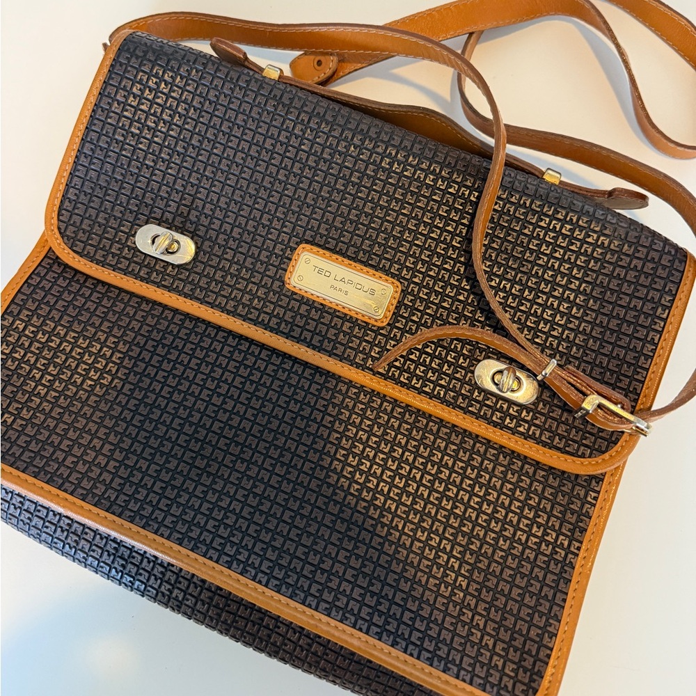 This is a vintage Ted Lapidus Signature logo embossed handbag in brown leather